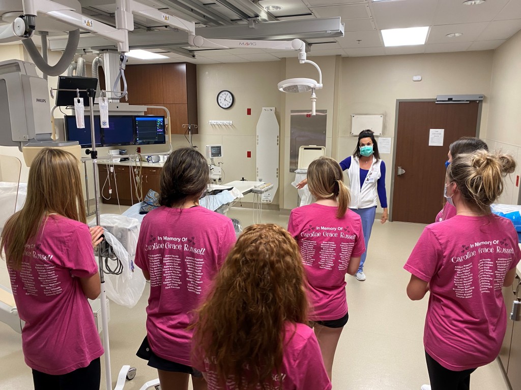 Cardiac Cath Lab Tech Christy Connie RT(R) explains the process of preparing a patient for cardiac catheterization to a group of Hot Springs Sweethearts in one of the National Park Medical Center cardiac cath labs.