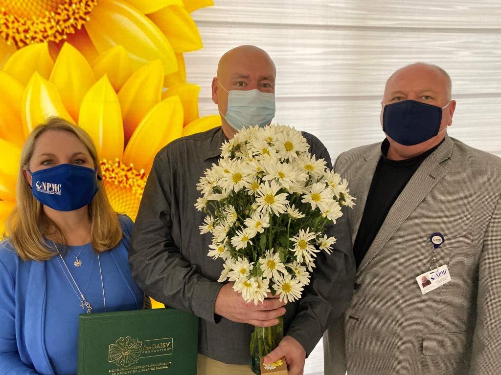 Inaugural NPMC Daisy Award Winner, Matt McFarland, RN, (center) with NPMC's CNO, Lisa Wallace (left) and CEO, Scott Smith (Right) 