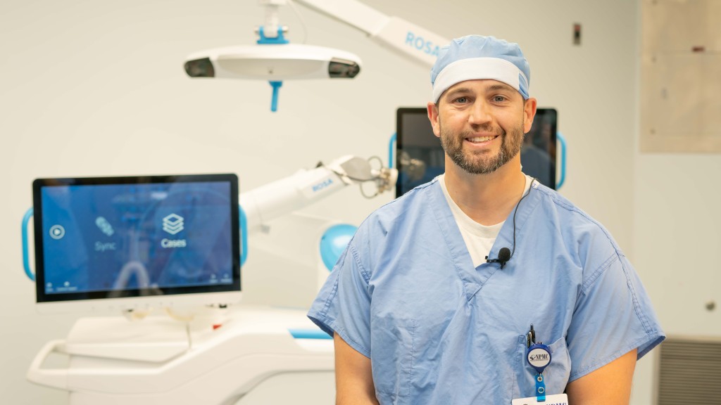 Orthopedic Surgeon, Dr. Michael Hubbard, stands with the ROSA system in an operating suite at NPMC